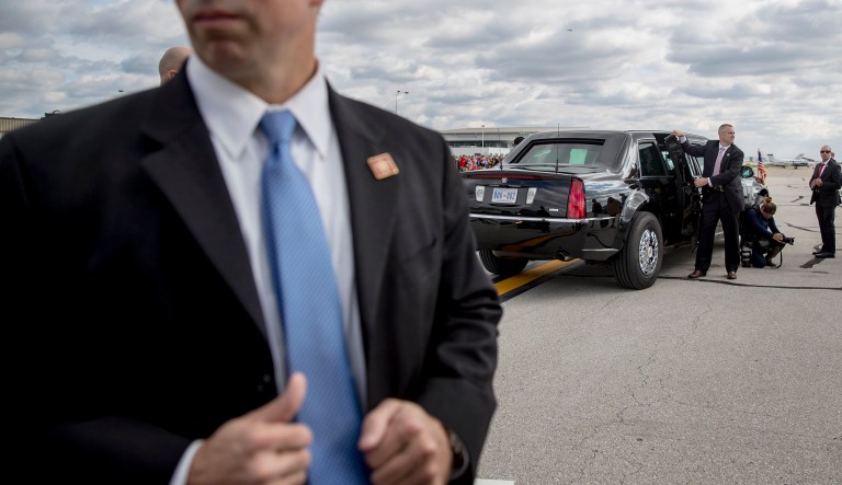 Secret Service agents stand on the tarmac with a presidential limo as President Donald Trump arrives at Indianapolis International Airport in Indianapolis, Saturday, Oct. 27, 2018, to speak at the 91st Annual Future Farmers of America Convention and Expo.