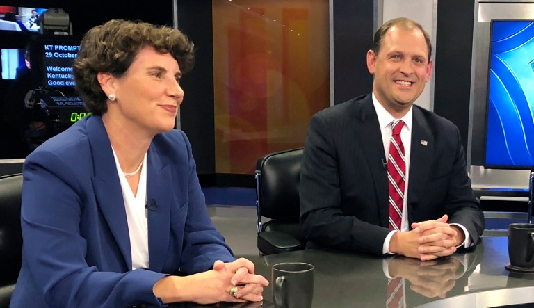 In this Oct. 29, 2018 photo, Kentuckyâs 6th Congressional District candidates Amy McGrath, left, Andy Barr, center, pose for photos before the start of a debate in Lexington, Ky.