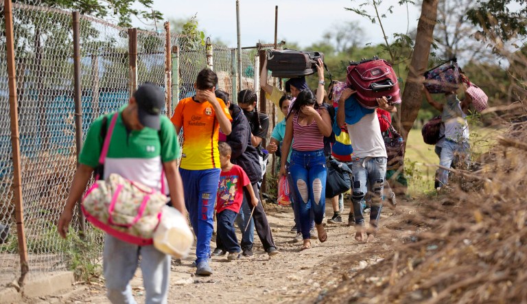 Venezuelans illegally cross into Colombia, to Villa del Rosario, along a path known as a "trocha."