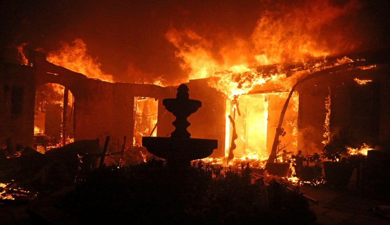 A Spanish-style home is consumed by flames on Dume Drive in the Point Dume area of Malibu, Calif., Friday, Nov. 9, 2018. Known as the Woolsey Fire, it has consumed tens of thousands of acres and destroyed multiple homes.