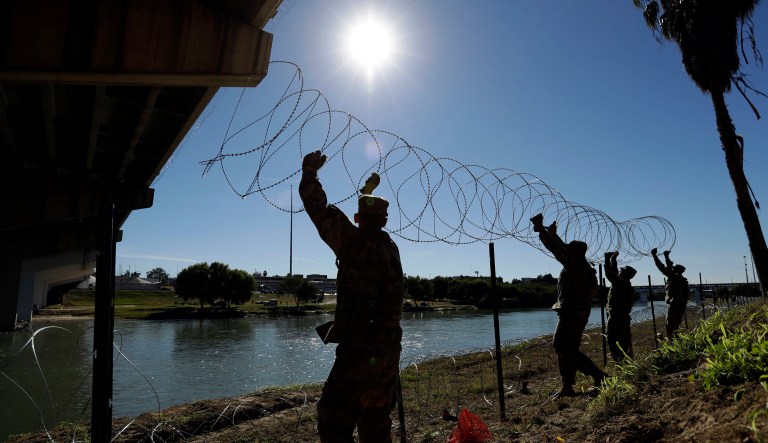 Members of the U.S. military install multiple tiers of concertina wire along the banks of the Rio Grande near the Juarez-Lincoln Bridge at the U.S.-Mexico border, Friday, Nov. 16, 2018, in Laredo, Texas.