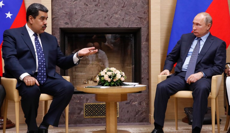 Venezuelan President Nicolas Maduro, left, gestures as he speaks to Russian President Vladimir Putin during meeting at the Novo-Ogaryovo residence outside in Moscow, Russia, Wednesday, Dec. 5, 2018. 