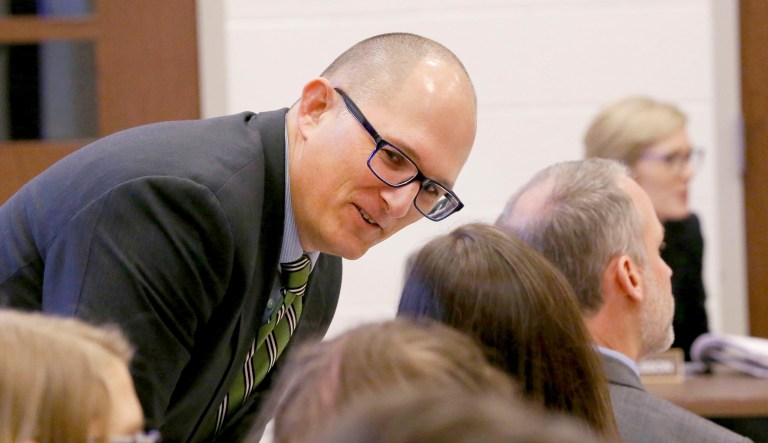 High school teacher Peter Vlaming chats at a West Point School Board hearing in West Point, Va. The board voted unanimously to dismiss Vlaming, a high school teacher who refused to use a transgender student's new pronouns. 