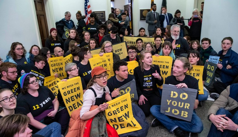 Environmental activists occupy the office of Rep. Steny Hoyer, D-Md., the incoming majority leader, as they try to pressure Democratic support for a sweeping agenda to fight climate change, on Capitol Hill in Washington, Monday, Dec. 10, 2018. 