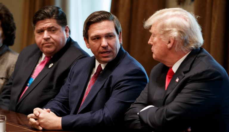 Governor-elect Ron DeSantis (R-FL, center) talks with President Donald Trump (right) during a meeting with newly elected governors in the Cabinet Room of the White House, Thursday, Dec. 13, 2018, in Washington