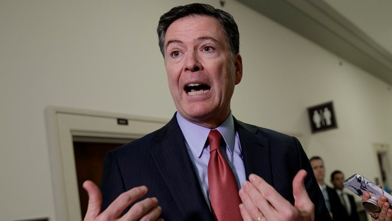 Former FBI Director James Comey speaks to reporters on Capitol Hill.