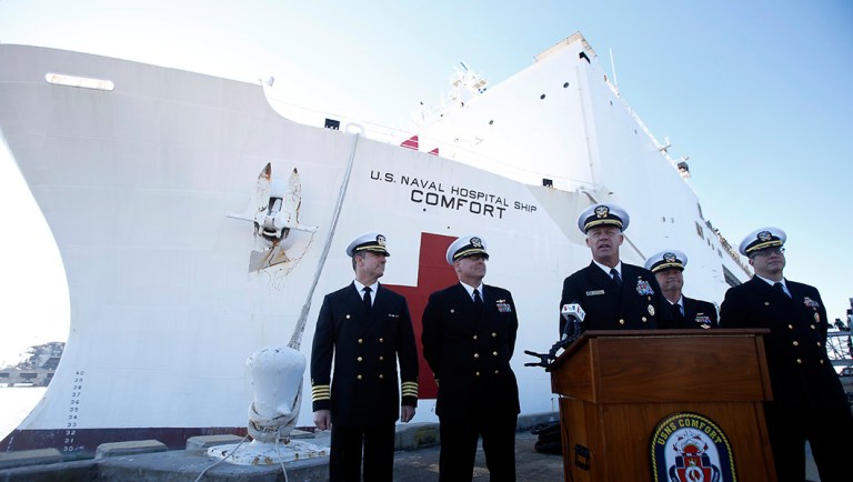 Rear Admiral Sean Buck, at podium, Commander of US Naval Forces 4th Fleet, addresses the media.