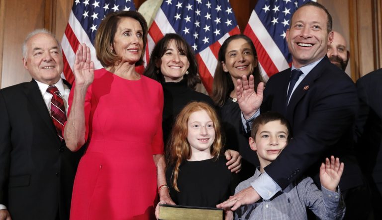House Speaker Nancy Pelosi of Calif., left, poses during a ceremonial swearing-in with Rep. Josh Gottheimer, D-N.J., right, on Capitol Hill, Thursday, Jan. 3, 2019 in Washington during the opening session of the 116th Congress.