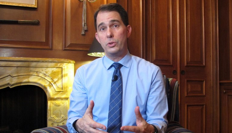 Ousted Republican Wisconsin Gov. Scott Walker talks to the media.