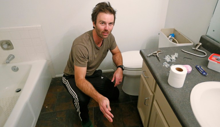 Federal contractor Chris Erickson preps before painting his bathroom Friday, Jan., 4, 2019, in North Salt Lake, Utah. Erickson says he'll run out of vacation days if the shutdown continues. The father of three from Salt Lake City will then crack into his savings, and he'll likely postpone a 14th wedding anniversary trip with his wife to a cabin. Erickson said he likely won't get the chance for reimbursement for the lost days because he's a contractor.