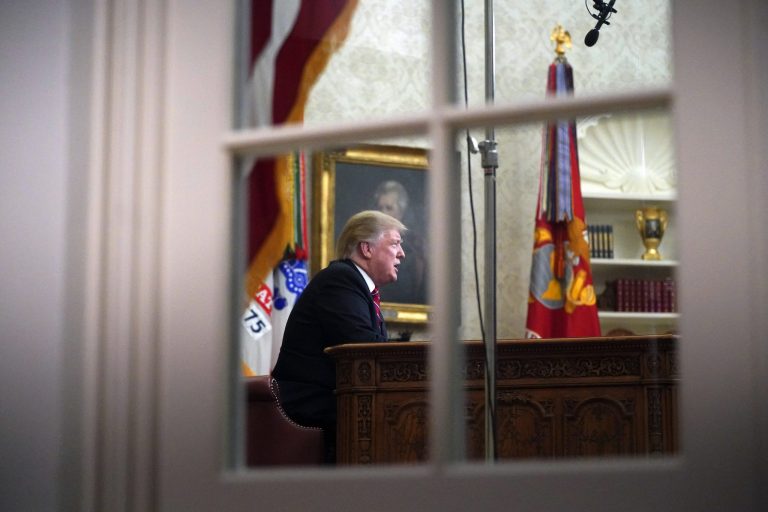 As seen from a window outside the Oval Office, President Donald Trump gives a prime-time address about border security Tuesday, Jan. 8, 2018, at the White House in Washington.