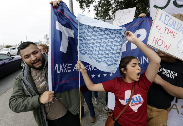 Border wall foes and supporters clash outside the McAllen International Airport as they wait for the arrival of President Donald Trump who is making a visit to the southern border, Thursday, Jan. 10, 2019, in McAllen, Texas. 