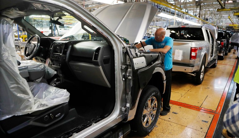 In this Sept. 27, 2018, file photo a United Auto Workers assemblyman works on a 2018 Ford F-150 truck being assembled at the Ford Rouge assembly plant in Dearborn, Mich.