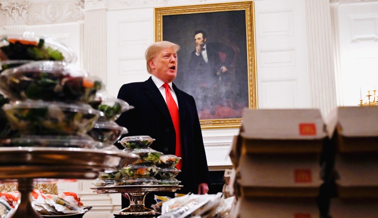 President Trump talks to the press about the table full of fast food in the State Dining Room of the White House.