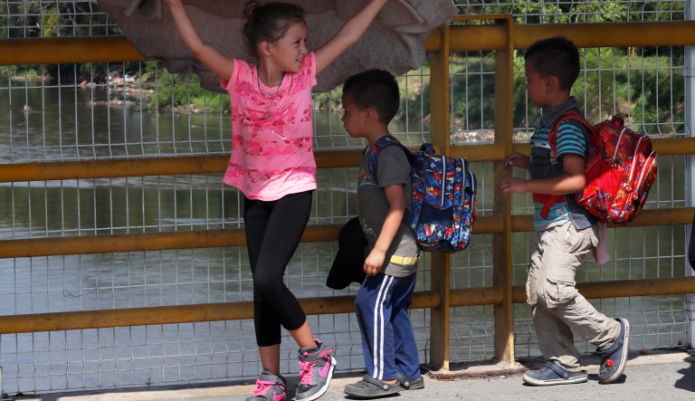 Children walk across the Suchiate river bridge as Central American migrants cross the border between Guatemala and Mexico, near Ciudad Hidalgo, Chiapas State, Mexico, Thursday, Jan. 17, 2019. Hundreds of Central American migrants are walking and hitchhiking through the region as part of a new caravan of migrants hoping to reach the United States.