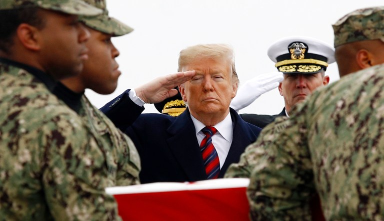 President Trump salutes as a U.S. Navy carry team moves a transfer case containing the remains of Scott A. Wirtz, Saturday, Jan. 19, 2019, at Dover Air Force Base, Del. According to the Department of Defense, Wirtz, a civilian and former Navy SEAL from St. Louis, Mo., was killed Jan. 16, 2019, in a suicide bomb attack in Manbij, Syria.