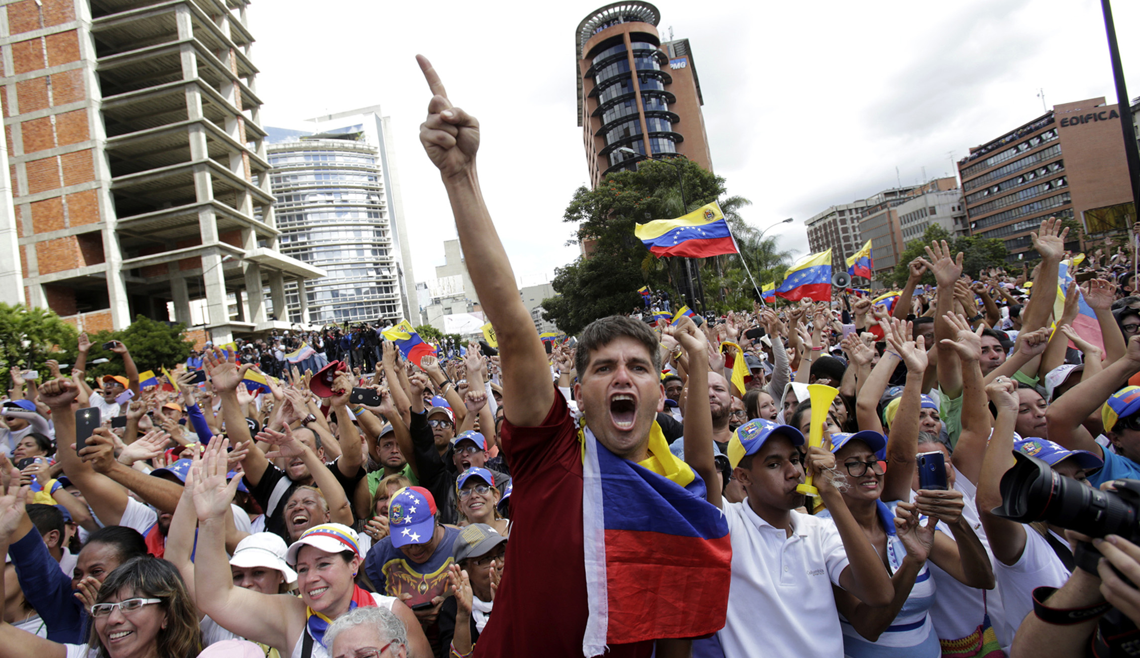 Anti-government protesters in Caracas, Venezuela, cheer as Juan Guaido, head of Venezuela's opposition-run congress, speaks at a rally demanding the resignation of President Nicolas Maduro.