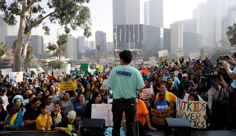 Charter school graduate Manuel Vasquez, center, rallies a crowd in support of charter schools outside the Los Angeles Unified School District headquarters Tuesday, Jan. 29, 2019, in Los Angeles. The Los Angeles Unified School District Board of Education unanimously ratified a contract with teachers that ended a strike while also approving a resolution asking the state to put new charter schools on hold while the state studies their effects.