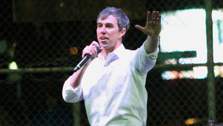 Former Rep. Beto O'Rourke speaks to a crowd inside a ball park.