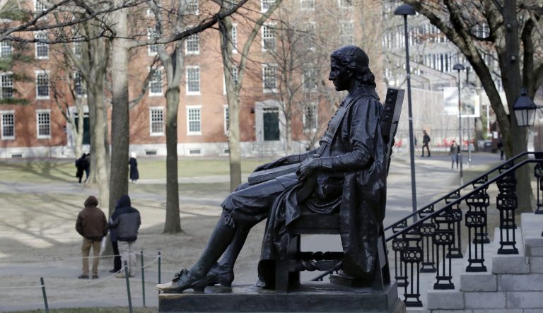 In this Dec. 13, 2018 photo, the John Harvard statue looks over Harvard Yard at Harvard University in Cambridge, Mass. 
