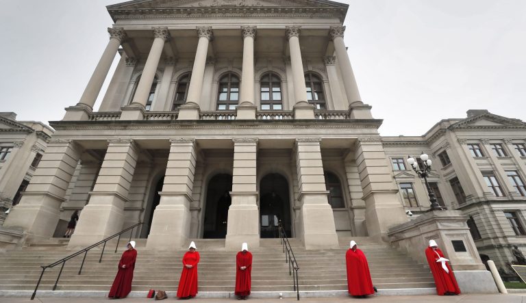 Georgia members of the Handmaid Coalition protest the passage of HB 481 outside the Capitol, Friday, March 8, 2019, in Atlanta. 