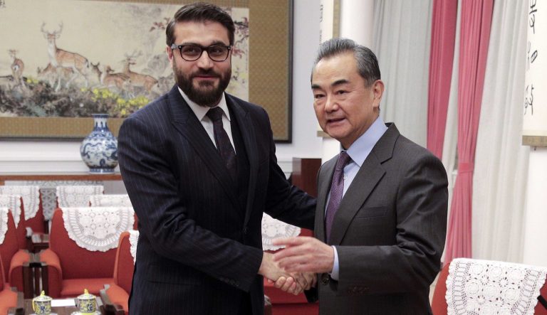 In this Jan. 10, 2019 photo, Afghanistan national security adviser Hamdullah Mohib, left, shakes hands with Chinese Foreign Minister Wang Yi before proceeding to their meeting at the Zhongnanhai Leadership Compound in Beijing. Hamdullah Mohib is blasting U.S. talks with the Taliban, saying the Trump administration has alienated the Afghan government, legitimized the militant network and is crafting a deal that will never lead to peace. 