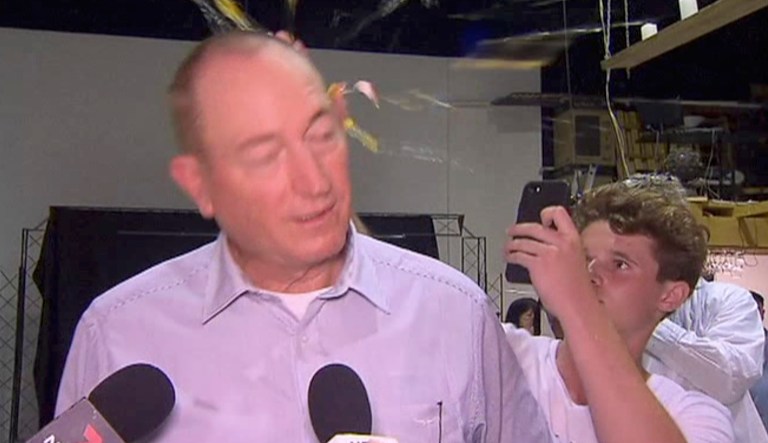 In this image made from video, a teenager breaks an egg on the head of Sen. Fraser Anning while he holds a press conference, Saturday, March 16, 2019, in Melbourne, Australia.