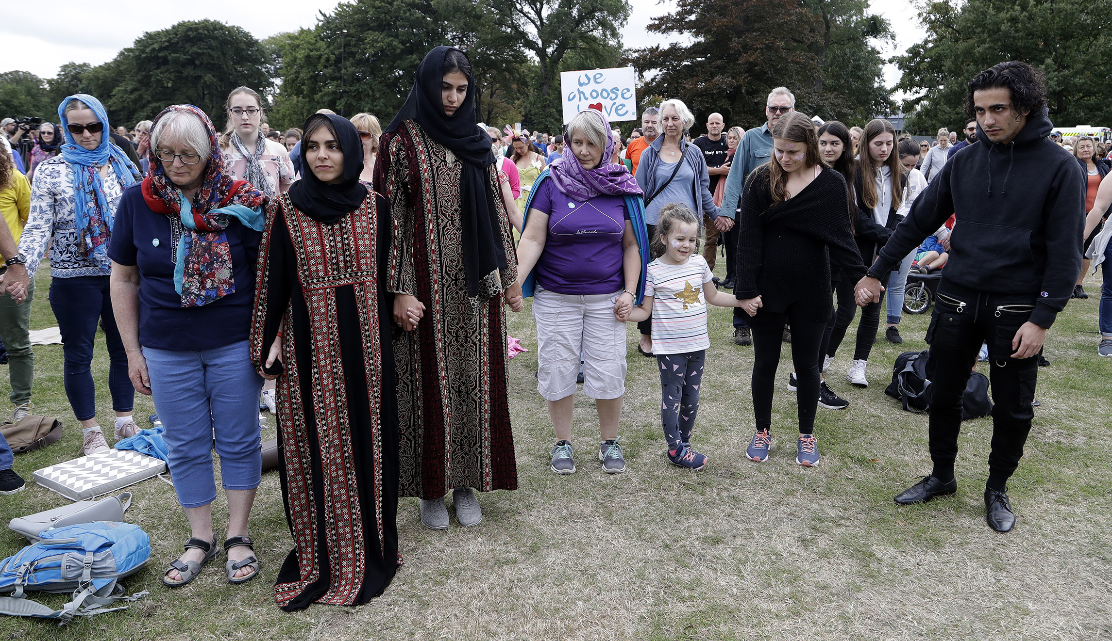 Students and members of the public hold hands during a minutes silence ahead of the "March for Love" following last week's mosque attacks in Christchurch, New Zealand, Saturdaay.