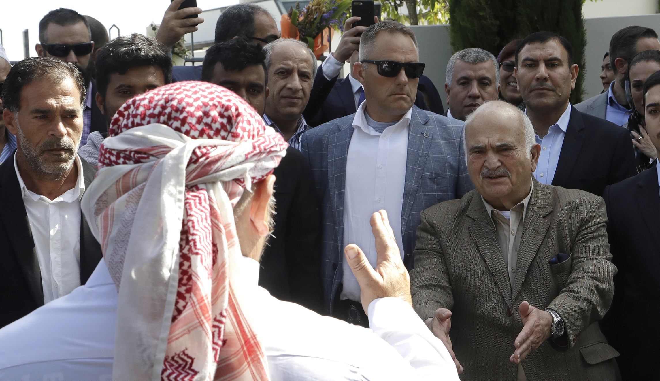 His Royal Highness Prince Hassan bin Talal Hashemite, second right, of Jordan, greets a worshipper who had just performed a haka outside the Al Noor mosque in Christchurch, New Zealan.