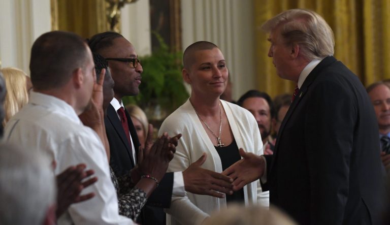 President Trump, right, shakes hands with former prisoner Gregory Allen, third from right, as former prisoner Alice Johnson, second from right, watches, during the 2019 Prison Reform Summit and First Step Act Celebration in the East Room of the White House in D.C.