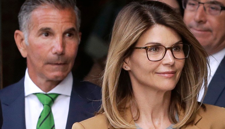 Actress Lori Loughlin, front, and husband, clothing designer Mossimo Giannulli, left, depart federal court in Boston on Wednesday, April 3, 2019, after facing charges in a nationwide college admissions bribery scandal. 
