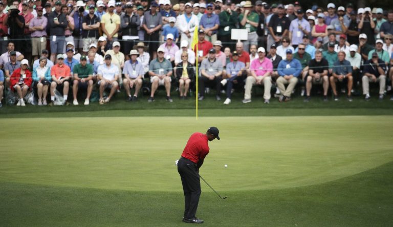 Tiger Woods hits to the fourth green during the final round for the Masters golf tournament, Sunday, April 14, 2019, in Augusta, Ga. 