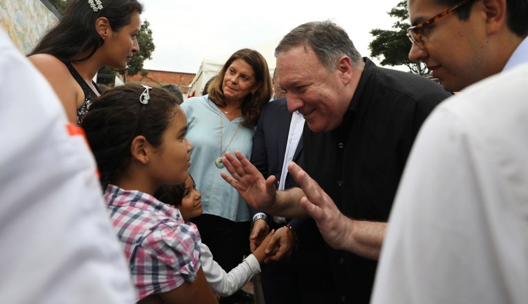 U.S. Secretary of State Mike Pompeo, center right, greets a Venezuelan migrant family who is staying at a migrant shelter, as he's given a tour by Colombian Vice President Marta Lucia Ramirez, right, and Colombian President Ivan Duque, center, in La Parada near Cucuta, Colombia, on the border with Venezuela.