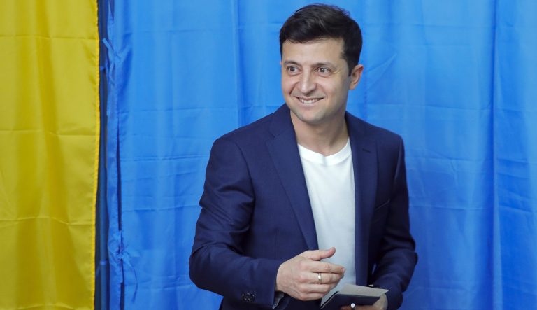 Ukrainian comedian and presidential candidate Volodymyr Zelenskiy, center, leaves a booth at a polling station during the second round of presidential elections in Kiev, Ukraine, Sunday, April 21, 2019. 