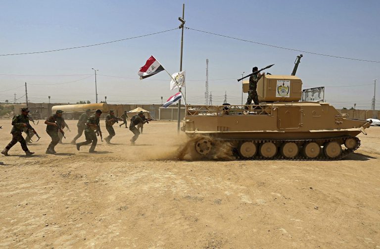 In this July 18, 2017 photo, Shiite Volunteer fighters from the Imam Ali Brigade, an armed faction with the Iraqi Popular Mobilization Forces, train at their camp, in Najaf, 100 miles (160 kilometers) south of Baghdad, Iraq. When U.S. Secretary of State Mike Pompeo sat down with Iraqi officials in Baghdad earlier this month as tensions were mounting between the U.S. and Iran, he delivered a nuanced message: If you're not going to stand with us, stand aside. 