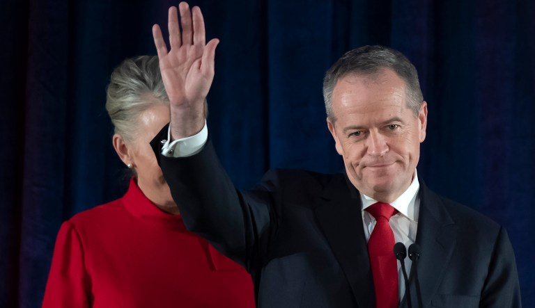 Australian Labor leader Bill Shorten gestures on stage with his wife Chloe, at the Federal Labor Reception in Melbourne, Australia, Saturday, May 18, 2019. Shorten has conceded defeat to Prime Minister Scott Morrison in the country's general election. Shorten made the announcement to supporters of his opposition Labor party late Saturday night in Melbourne.