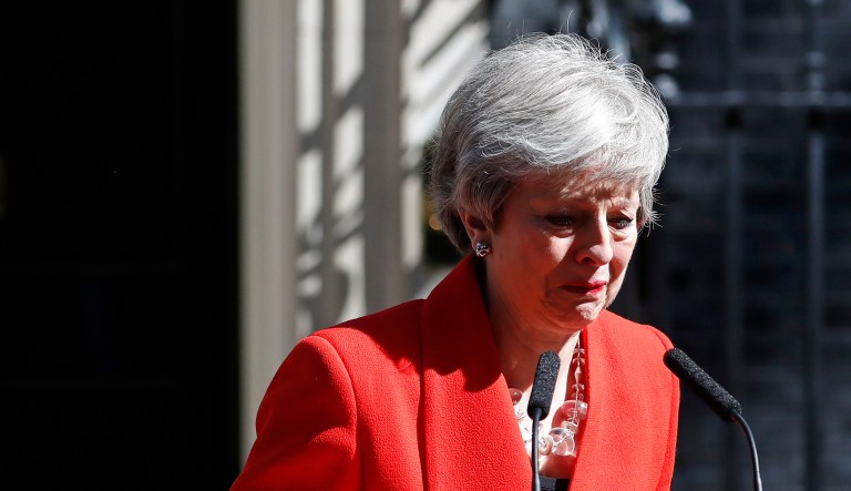 British Prime Minister Theresa May reacts as she turns away after making a speech in the street outside 10 Downing Street in London.