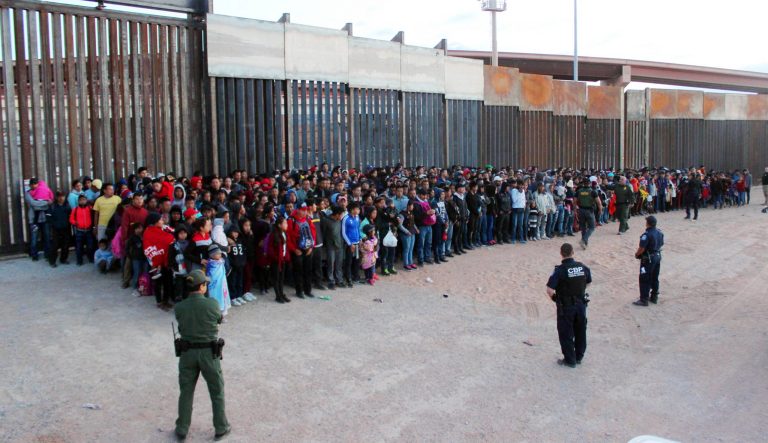 This May 29, 2019 photo released by U.S. Customs and Border Protection shows some of 1,036 migrants who crossed the U.S.-Mexico border in El Paso, Texas, the largest that the Border Patrol says it has ever encountered. The federal government is opening a new mass shelter for migrant children near the U.S-Mexico border and is considering housing children on three military bases to add 3,000 more beds to the overtaxed system in the coming weeks. 