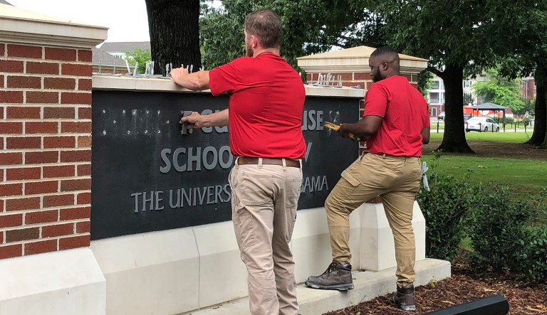 University of Alabama employees remove the name of Hugh F. Culverhouse Jr. off the School of Law sign in Tuscaloosa, Ala., Friday, June 7, 2019. The University of Alabama board of trustees voted Friday to give back a $26.5 million donation to a philanthropist Hugh F. Culverhouse Jr., who recently called on students to boycott the school over the state's new abortion ban.