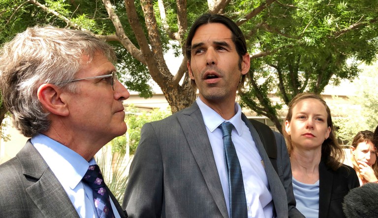Scott Warren, center, speaks outside federal court on Tuesday in Tucson, Ariz., after a mistrial was declared in the federal case against him. The jury announced it was deadlocked in the case against Warren, a border activist charged with conspiracy to transport and harbor migrants, in a trial that humanitarian aid groups said would have wide implications on their work.