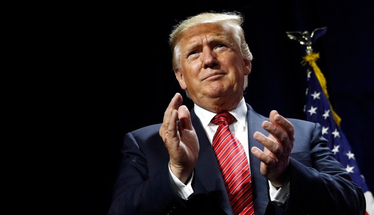 President Trump arrives at the Republican Party of Iowa's annual dinner in West Des Moines, Iowa.