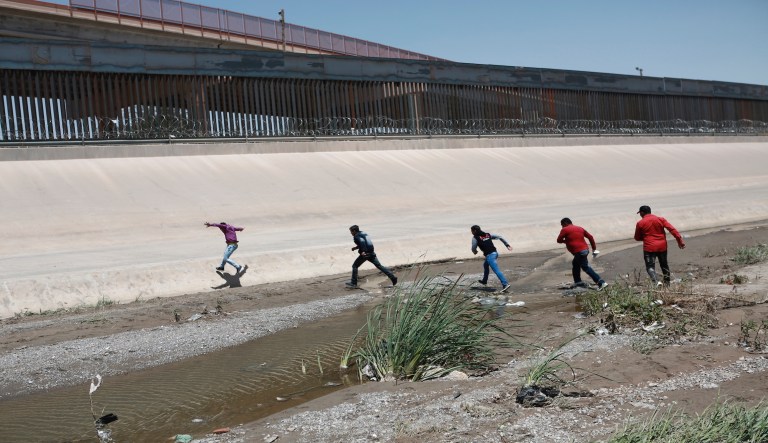 Migrants cross the Rio Bravo illegally to surrender to the American authorities, on the U.S.-Mexico border between Ciudad Juarez and El Paso.