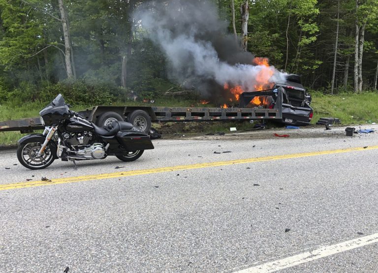 The scene where several motorcycles and a pickup truck collided on a rural, two-lane highway.