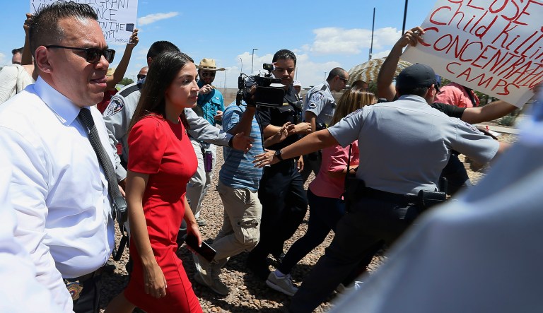 U.S. Rep. Alexandria Ocasio-Cortez, D-New York, is escorted back to her vehicle after she speaks at the Border Patrol station in Clint, Texas, about what she saw at area border facilities Monday, July 1, 2019. 