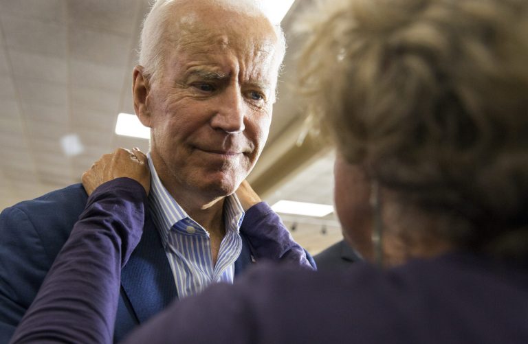 Former vice president and 2020 Democratic presidential candidate Joe Biden gets a hug from an audience member during a campaign stop at the Local 838 UAW Hall, Wednesday, July 3, 2019, in Waterloo, Iowa.