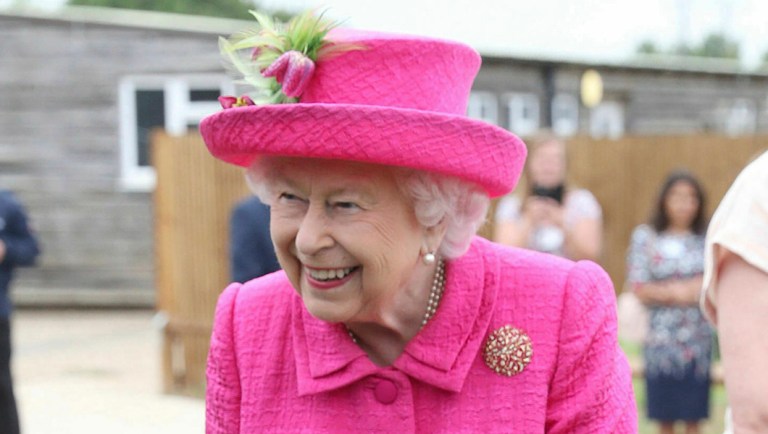 Britain's Queen Elizabeth II plants a tree.