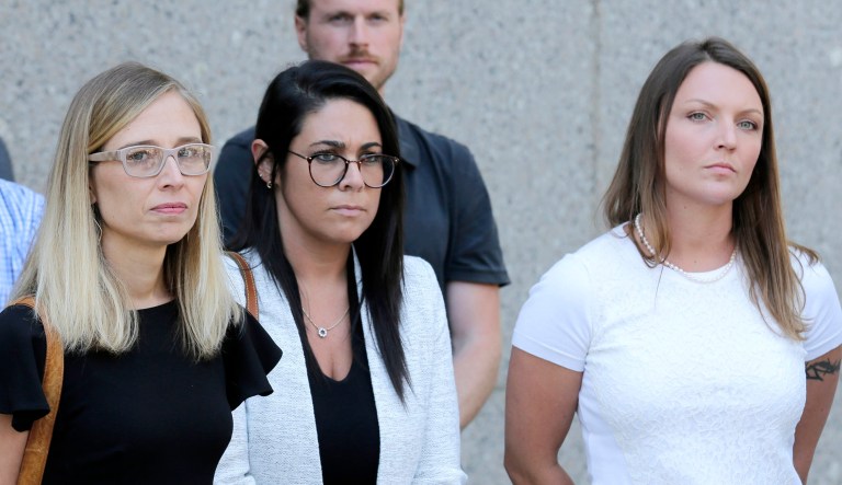 Annie Farmer (seen on far left) and Courtney Wild (right), alleged victims of Jeffery Epstein, stand outside the courthouse in New York, Monday.