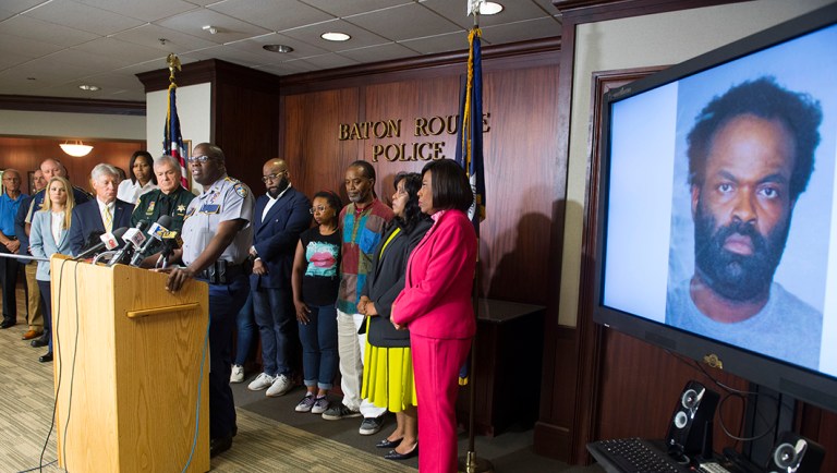 Baton Rouge area law enforcement officials announce the arrest of Ronn Jermaine Bell, 38, shown on monitor at right.