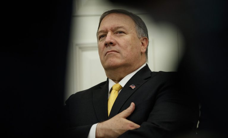 Secretary of State Mike Pompeo stands in the Oval Office of the White House in Washington, Friday, July 26, 2019, as Trump announced that Guatemala is signing an agreement to restrict asylum applications to the U.S. from Central America. 