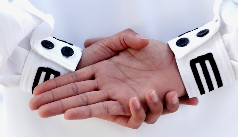 A sailor stands during a commissioning ceremony.